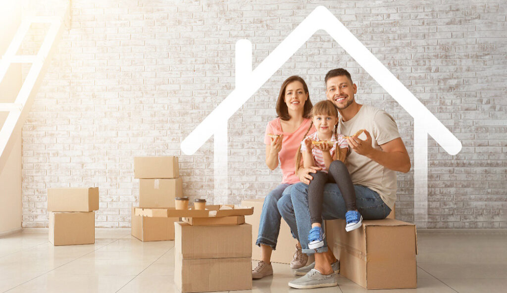 happy family sitting in their new home amid pile of boxes