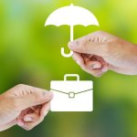 image of two hands holding white icons of a briefcase and an umbrella on a green bokeh background