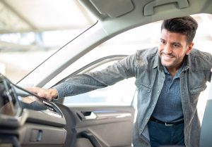 used car buyer looking at the inside of a car